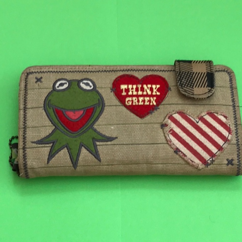 Kermit the frog think green wallet with striped canvas background.